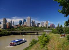 A paddlewheel boat crosses the North Saskatchewan River through Edmonton, Alberta